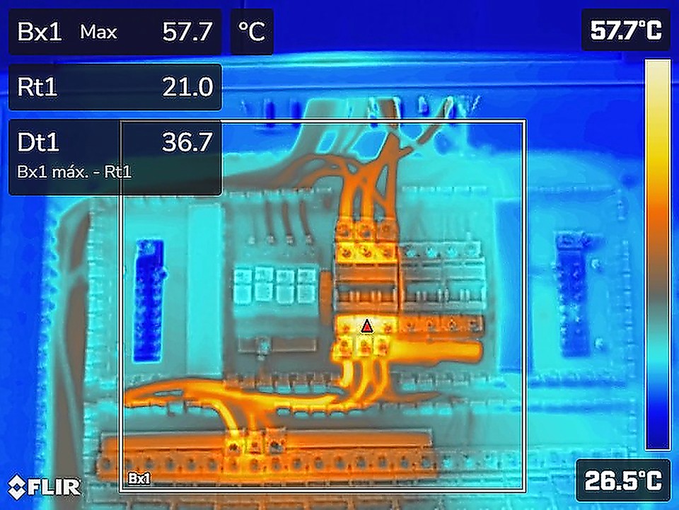 Termograma de quadro de distribuição elétrica mostrando ponto quente de 57,7 °C em conexão de disjuntor, contra 21,0 °C de referência — diferencial de 36,7 °C registrado em inspeção termográfica da IFELL Engenharia